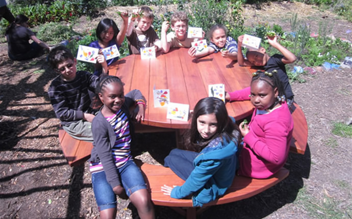 Round Picnic Table (A. B.) at Malcom X Elementary School.	By Rivka Mason of Oakland, CA.